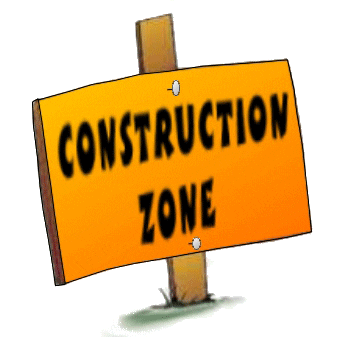 A construction zone sign is posted on the side of the road.